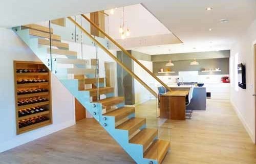 White steel staircase in modern house with glass panels