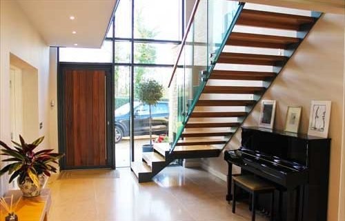 large hallway with piano and huge window with modern stair in front