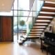 large hallway with piano and huge window with modern stair in front