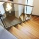 frameless glass balustrade to the side of a steel and wooden stair