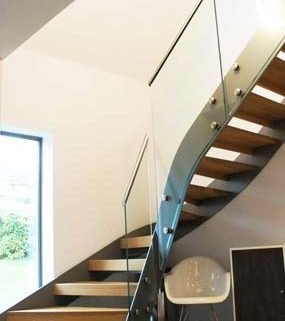 modern open riser stair with wooden steps and glass panels
