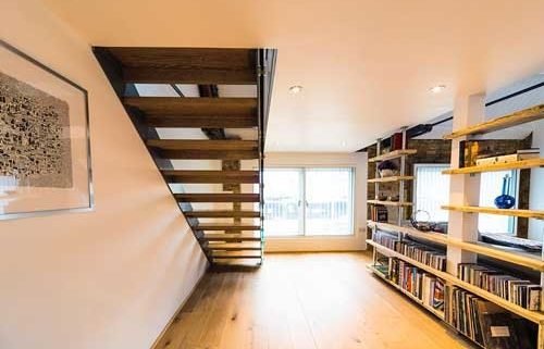 open riser staircase with bookcase to side