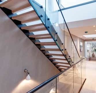 glass balustrade over stairwell with straight flight modern stair above