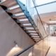 glass balustrade over stairwell with straight flight modern stair above
