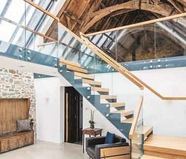 barn conversion with glass balustrade on a mezzanine level