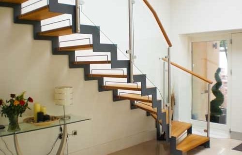 dark grey steel stringers on a timber step and open riser stair