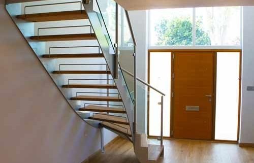 hallway with window and steel and glass staircase