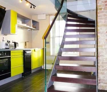 dark walnut open riser staircase with glass balustrade