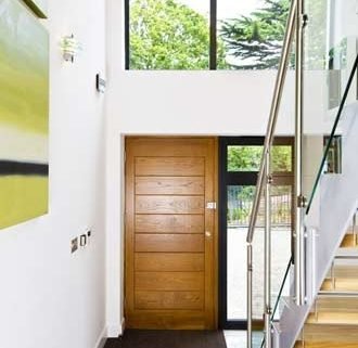 light and open hallway with steel stringers and glass balustrade