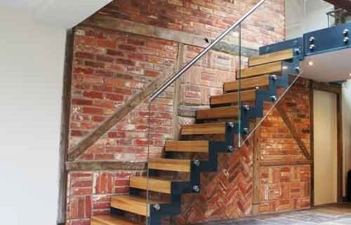 old brick wall behind a modern stair