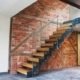 old brick wall behind a modern stair