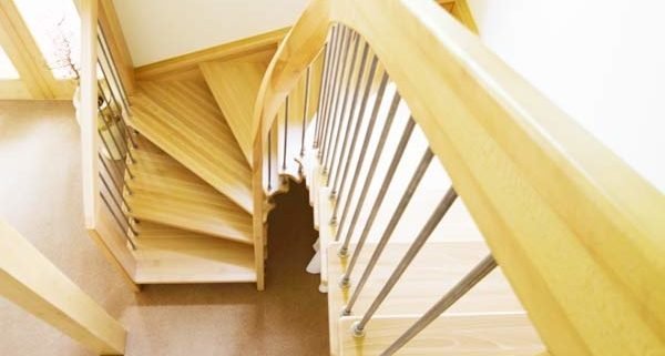 half turn wooden staircase with curving handrail