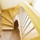 half turn wooden staircase with curving handrail