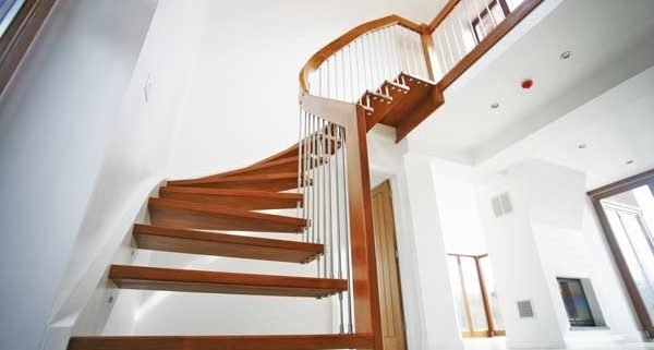 looking up at a curving quarter staircase in a floating style