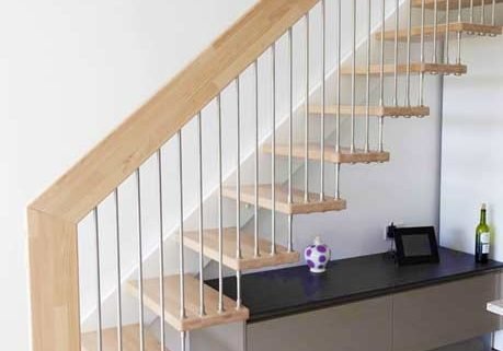 straight flight light wood open staircase with white wall stringer