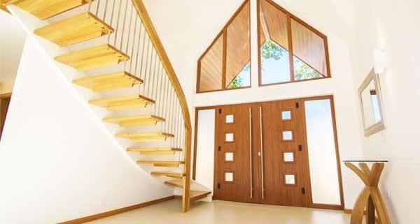 tiled floor in hallway with wooden front door and modern open staircase