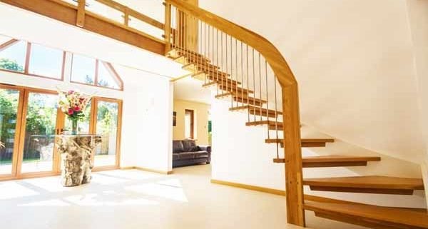 open riser staircase against a white wall in a modern hallway