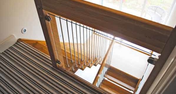 glass landing balustrade above a half turn oak stair