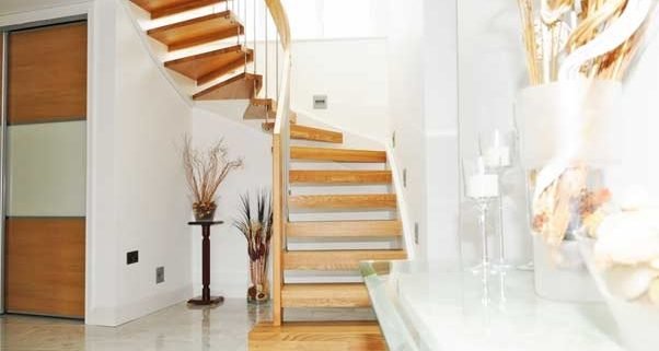 light tiled floor with oak open staircase in a half turn staircase