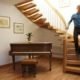oak curved staircase above a piano