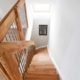 looking down a wooden staircase with landing balustrade