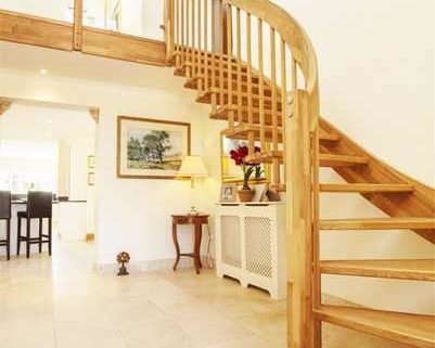 tiled floor and oak staircase ascending