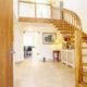 tiled floor with curving oak staircase rising