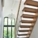 huge hallway featuring a straight flight wooden staircase with large window behind