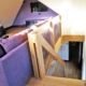looking down a stairwell with a purple sofa to one side