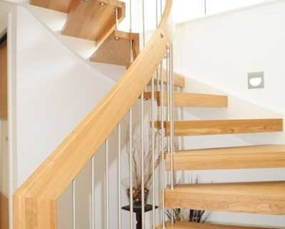 curved inner handrail of a floating wood staircase