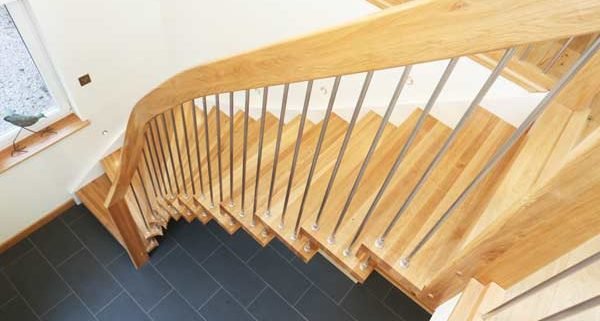 side view of an oak floating style stair with grey floor below