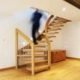 man coming down an oak staircase with open risers