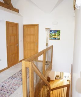 stairwell with oak balustrade and stainless spindles