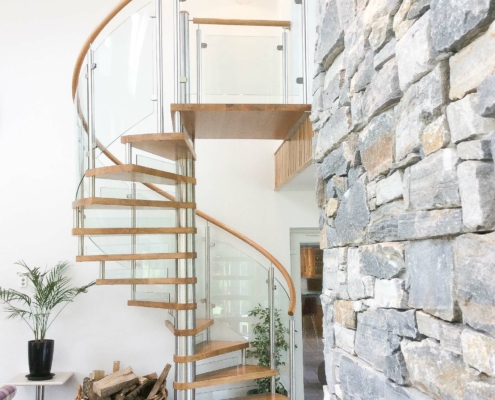 drystone wall feature and oak and glass spiral stair