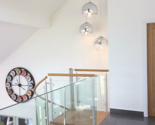 landing view of a tiled floor leading to a spiral staircase down