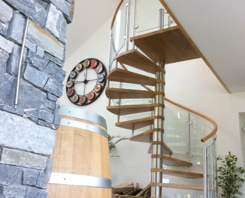 spiral staircase in oak with large wall clock