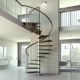 side view of spiral stair in a living space with white walls and windows