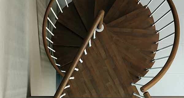 top view of triangular platform of a spiral staircase in dark wood
