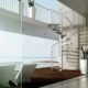 looking through window to the sea with outside spiral staircase rising to walkway