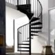white walled living space with black spiral rising to next level