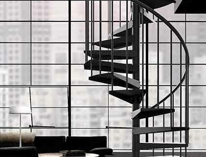 slimline black spiral staircase in from of a huge crittall window