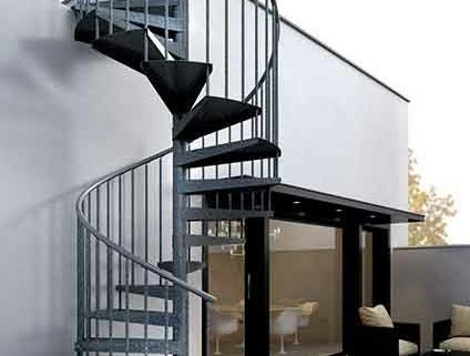 galvanised spiral stair running up the side of a domestic property