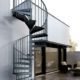 galvanised spiral stair running up the side of a domestic property
