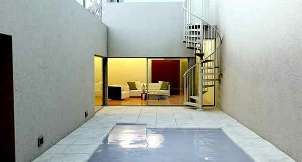 outdoor courtyard with patio and spiral stair in corner