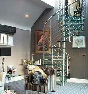 conventional sitting room with a glass spiral staircase. Sofa in foreground