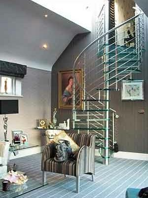 conventional sitting room with a glass spiral staircase. Sofa in foreground
