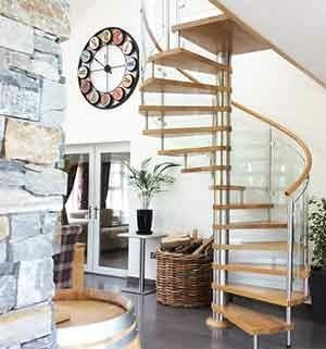spiral stair with curved glass panels and oak tread with a clock on the wall