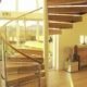 spiral stair with wooden steps and large window behind