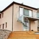external spiral stair with a balcony to the rear of a house