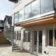 glass balustrade on an outside balcony of a house with a spiral stair